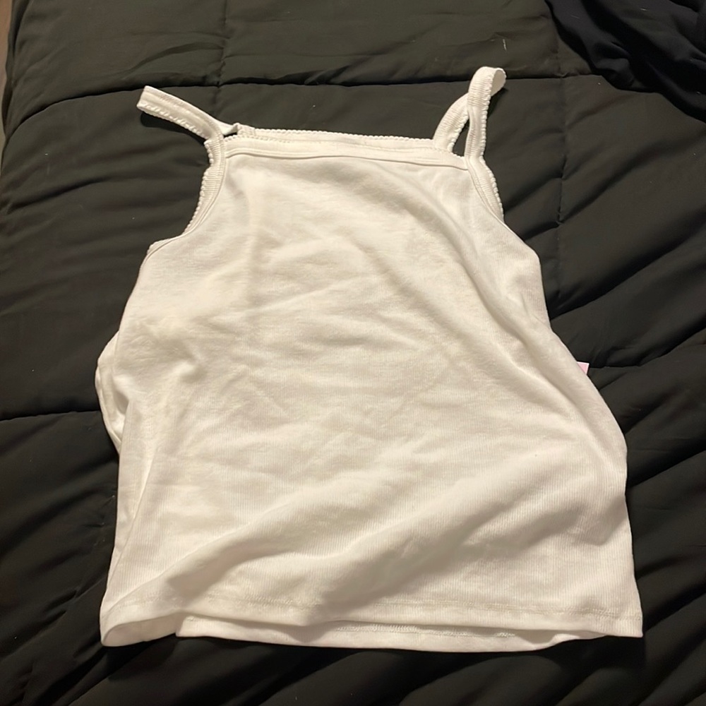 A white tank top with a patterned coller